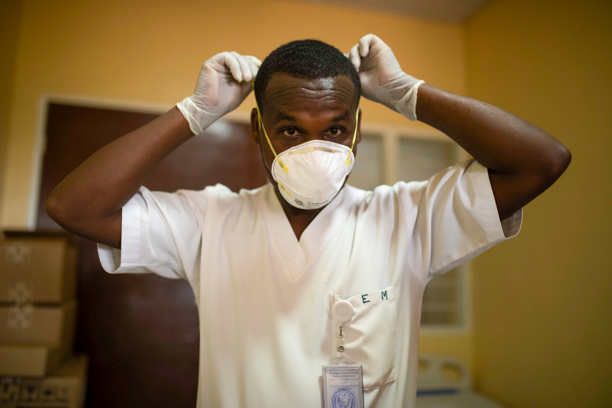 An Ingobyi project health worker in Rwamagana District, Rwanda starts to put on personal protective equipment to care for COVID-19 patients. Photo by Innocent Ishimwe for IntraHealth International.

